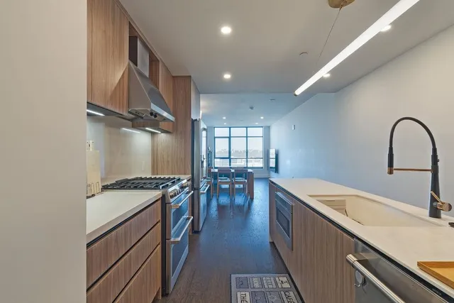 a kitchen with a stove a sink and a refrigerator
