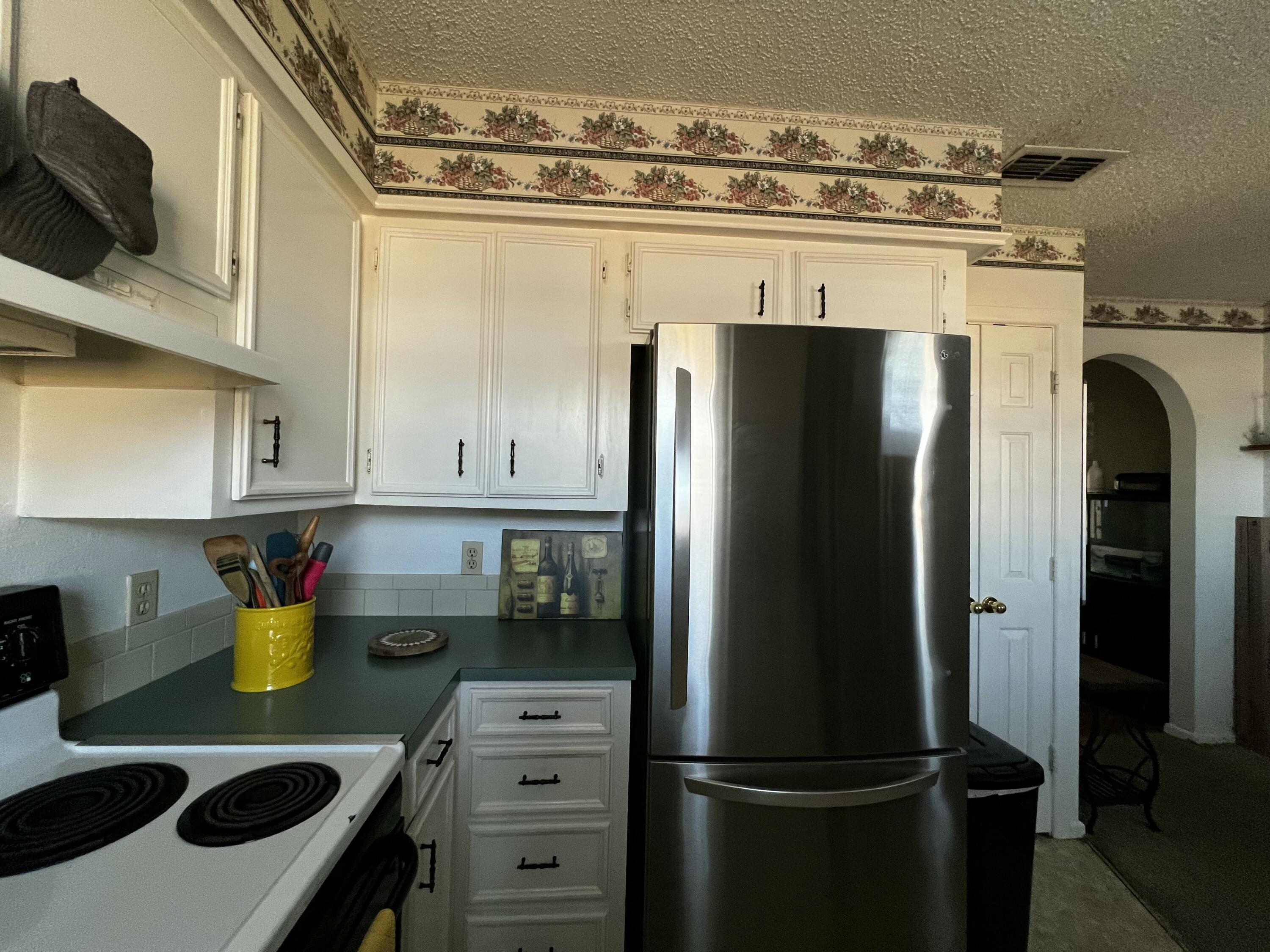 4520 36th Street Lubbock, TX 79414 - Photo 12 of 30 a kitchen with a refrigerator and a stove top oven