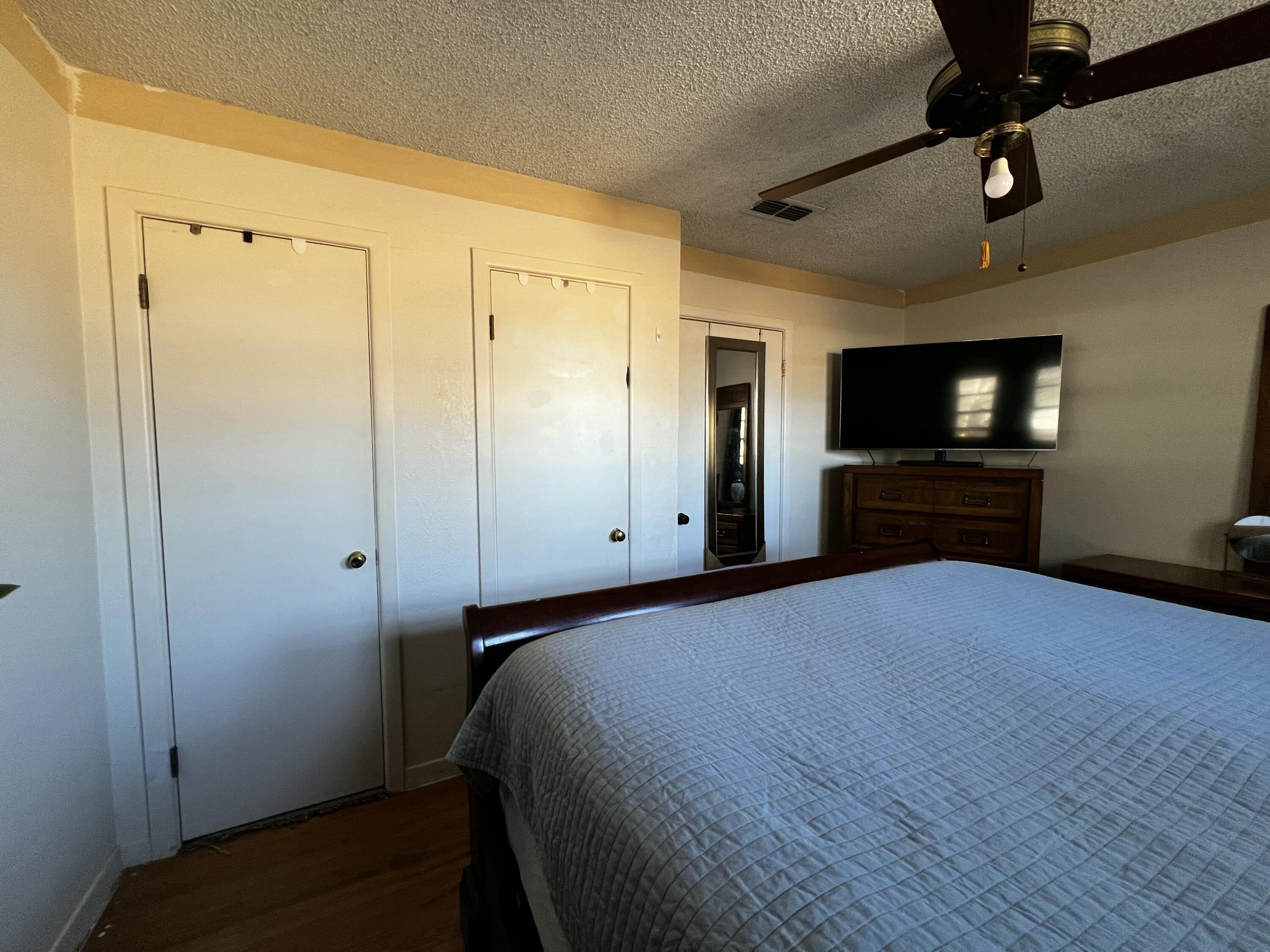 4520 36th Street Lubbock, TX 79414 - Photo 19 of 30 a bedroom with a bed and a flat screen tv