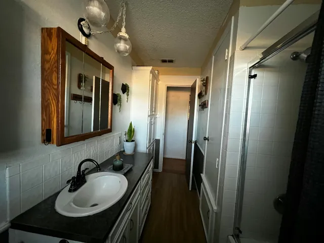 a bathroom with a glass shower door