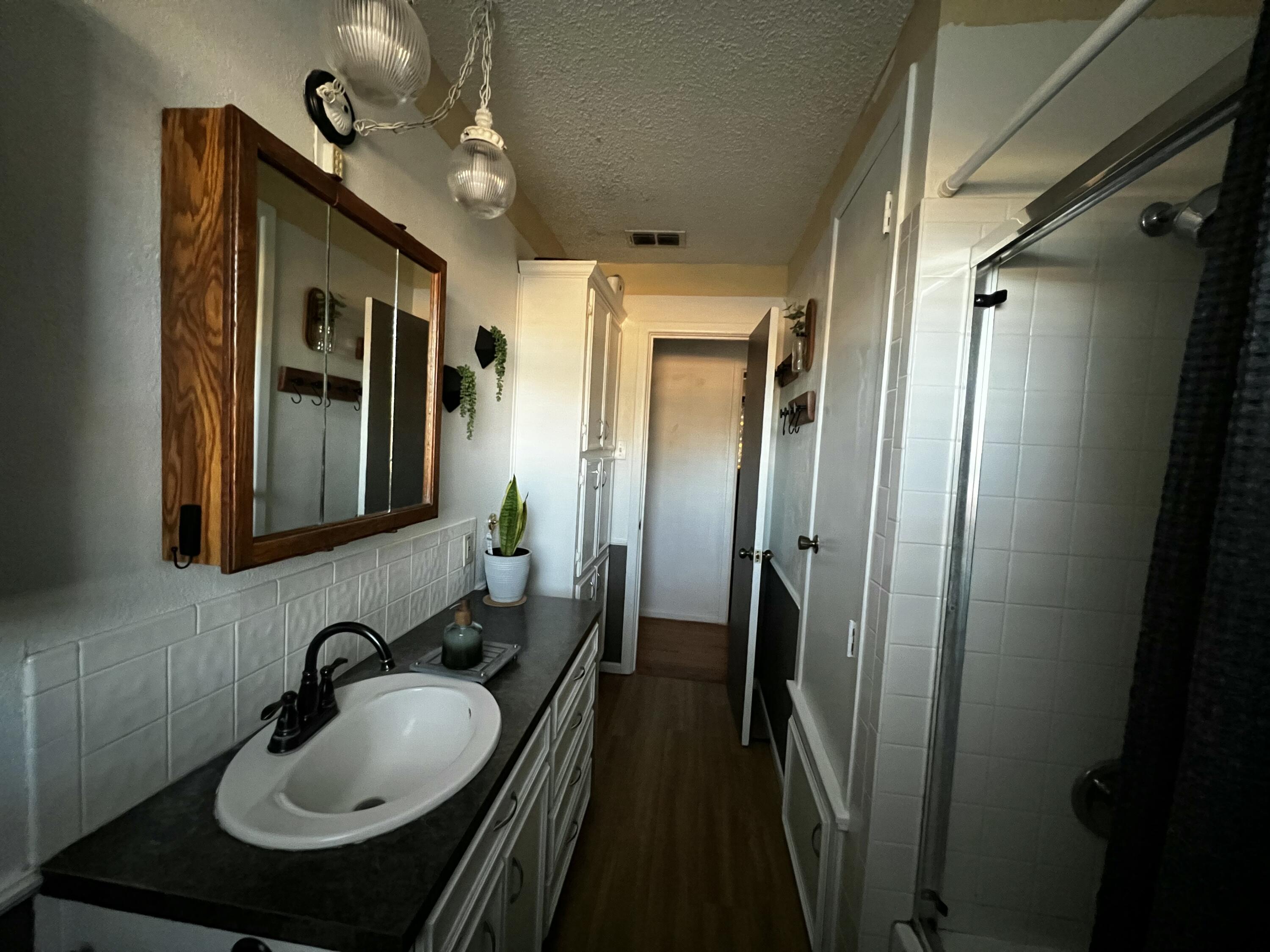 4520 36th Street Lubbock, TX 79414 - Photo 25 of 30 a bathroom with sink and mirror