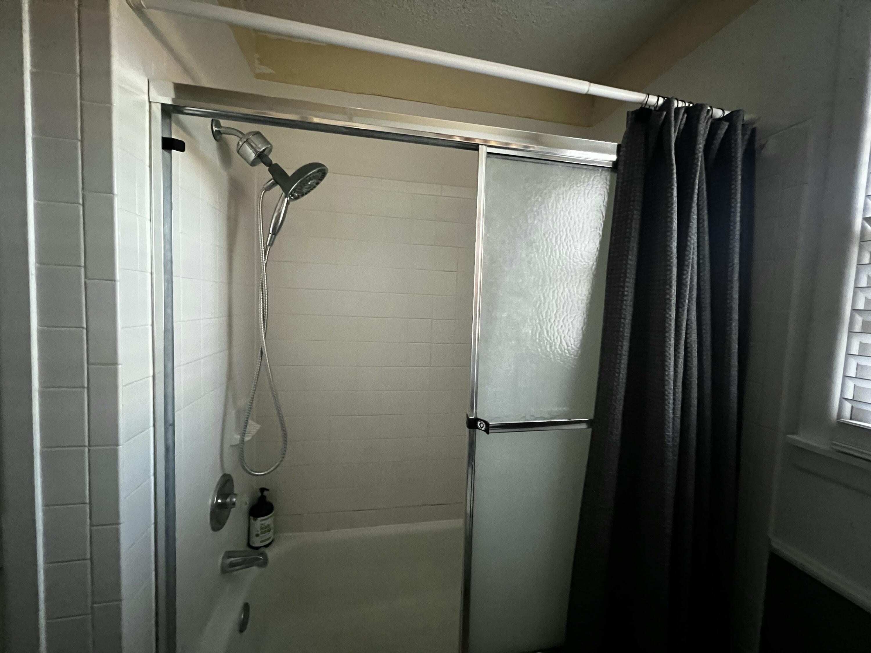 4520 36th Street Lubbock, TX 79414 - Photo 27 of 30 a bathroom with a glass shower door