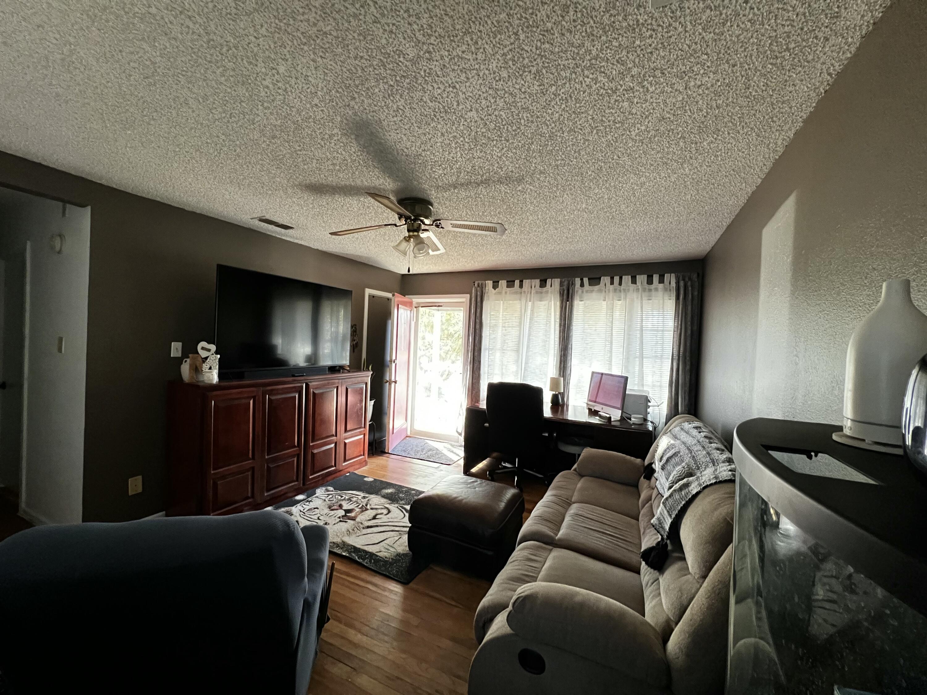 4520 36th Street Lubbock, TX 79414 - Photo 4 of 30 a living room with furniture and a flat screen tv