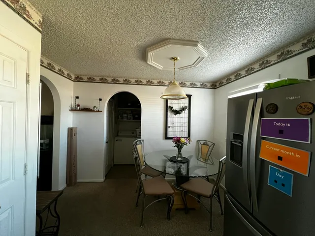a kitchen with a refrigerator and a stove top oven