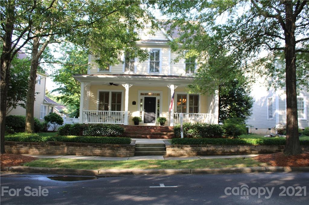 3022 Colonel Springs Way, Unit 171 Fort Mill, SC 29708 - Photo 1 of 30 a front view of a house with a garden and swimming pool