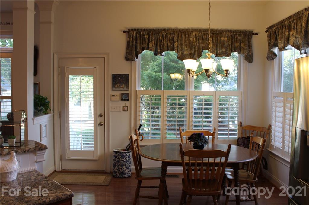 3022 Colonel Springs Way, Unit 171 Fort Mill, SC 29708 - Photo 12 of 30 a view of a dining room with furniture window and wooden floor