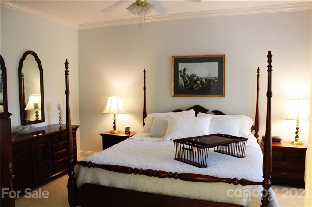 3022 Colonel Springs Way, Unit 171 Fort Mill, SC 29708 - Photo 13 of 30 a bedroom with a bed and dresser with mirror