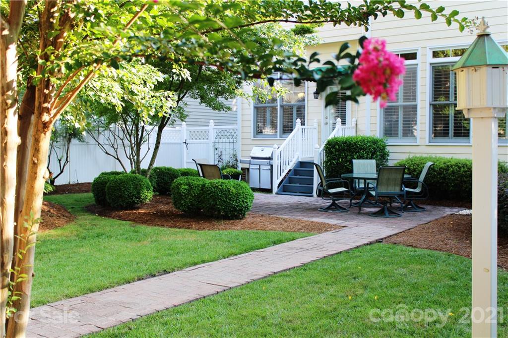 3022 Colonel Springs Way, Unit 171 Fort Mill, SC 29708 - Photo 17 of 30 a view of a house with backyard sitting area and garden