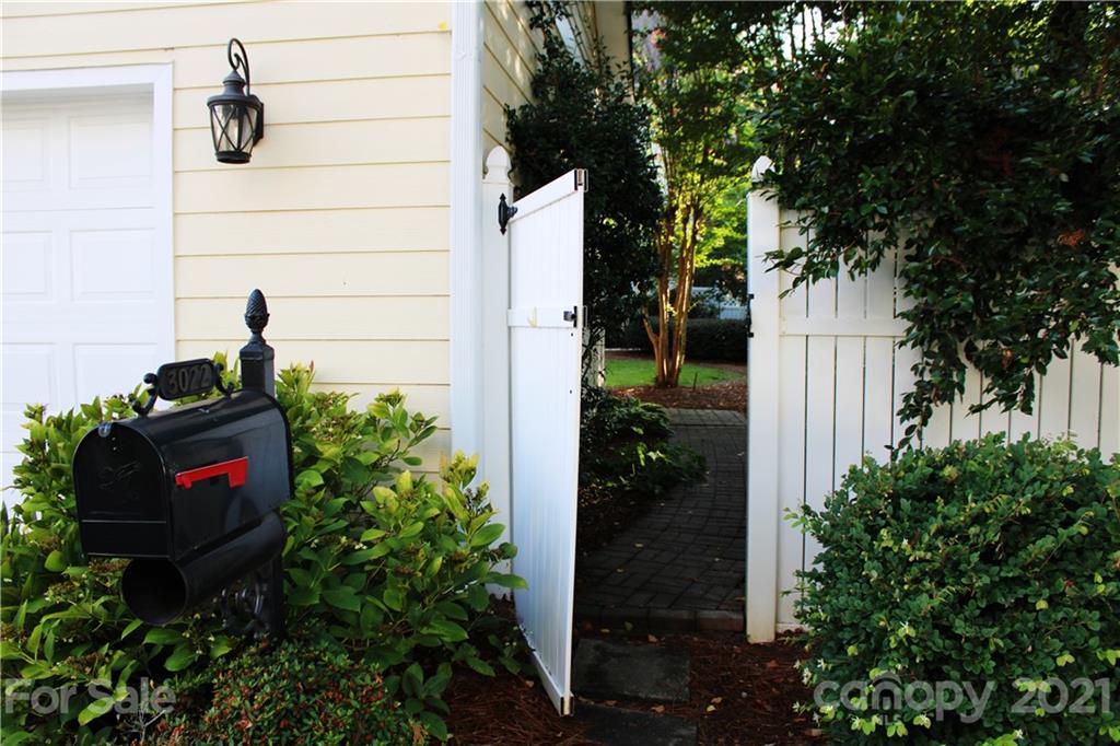 3022 Colonel Springs Way, Unit 171 Fort Mill, SC 29708 - Photo 24 of 30 a backyard with potted plants and a tree