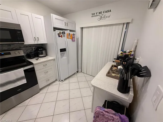 a kitchen with stainless steel appliances a sink and cabinets