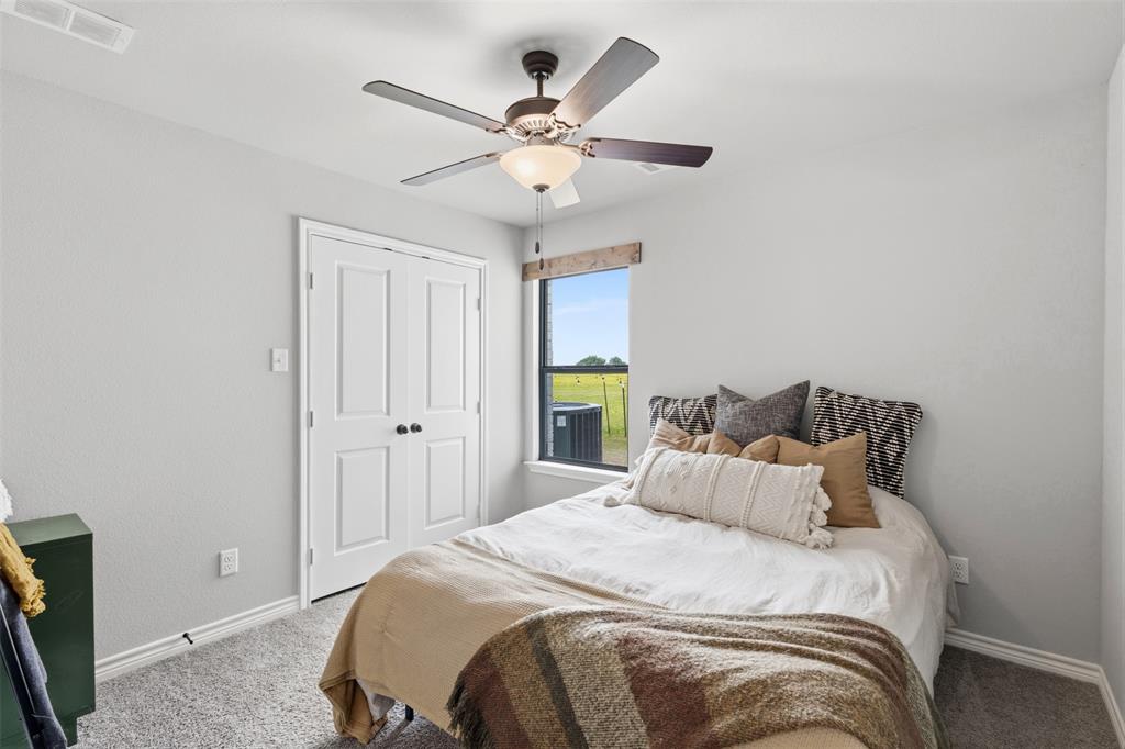 2990 Wilson Road Palmer, TX 75152 - Photo 27 of 40 a bedroom with a bed and a chandelier