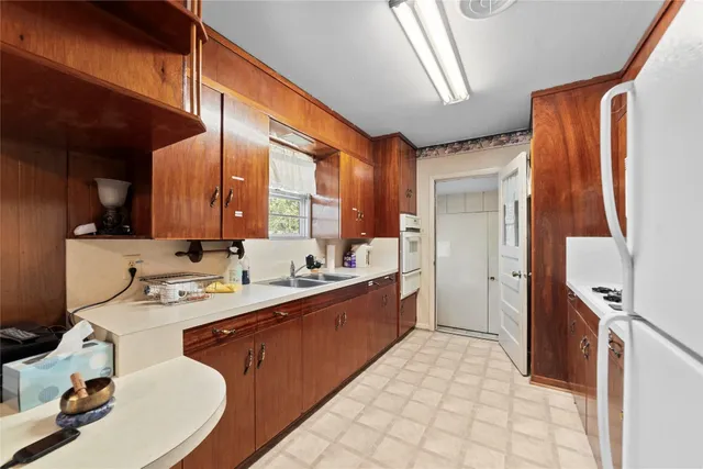 a large white kitchen with a large window