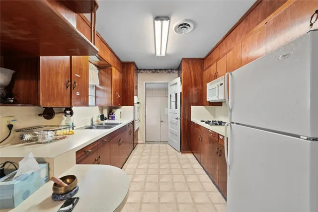 a kitchen with stainless steel appliances a sink stove and cabinets