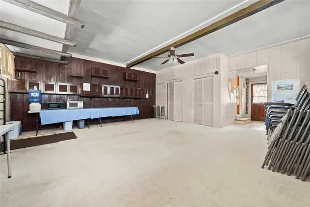 a view of a livingroom with workspace and a window