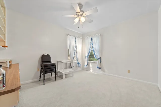 a view of a livingroom with a ceiling fan and window