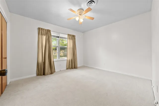 a view of a livingroom with a chandelier fan