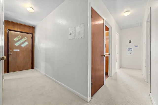 a view of a hallway with wooden shelves