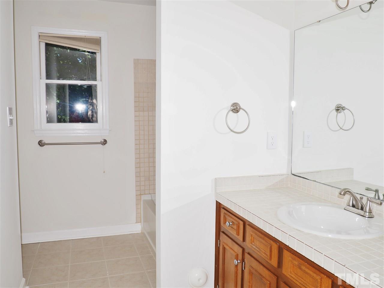 608 Maylands Avenue Raleigh, NC 27615 - Photo 12 of 14 a bathroom with a sink and a mirror