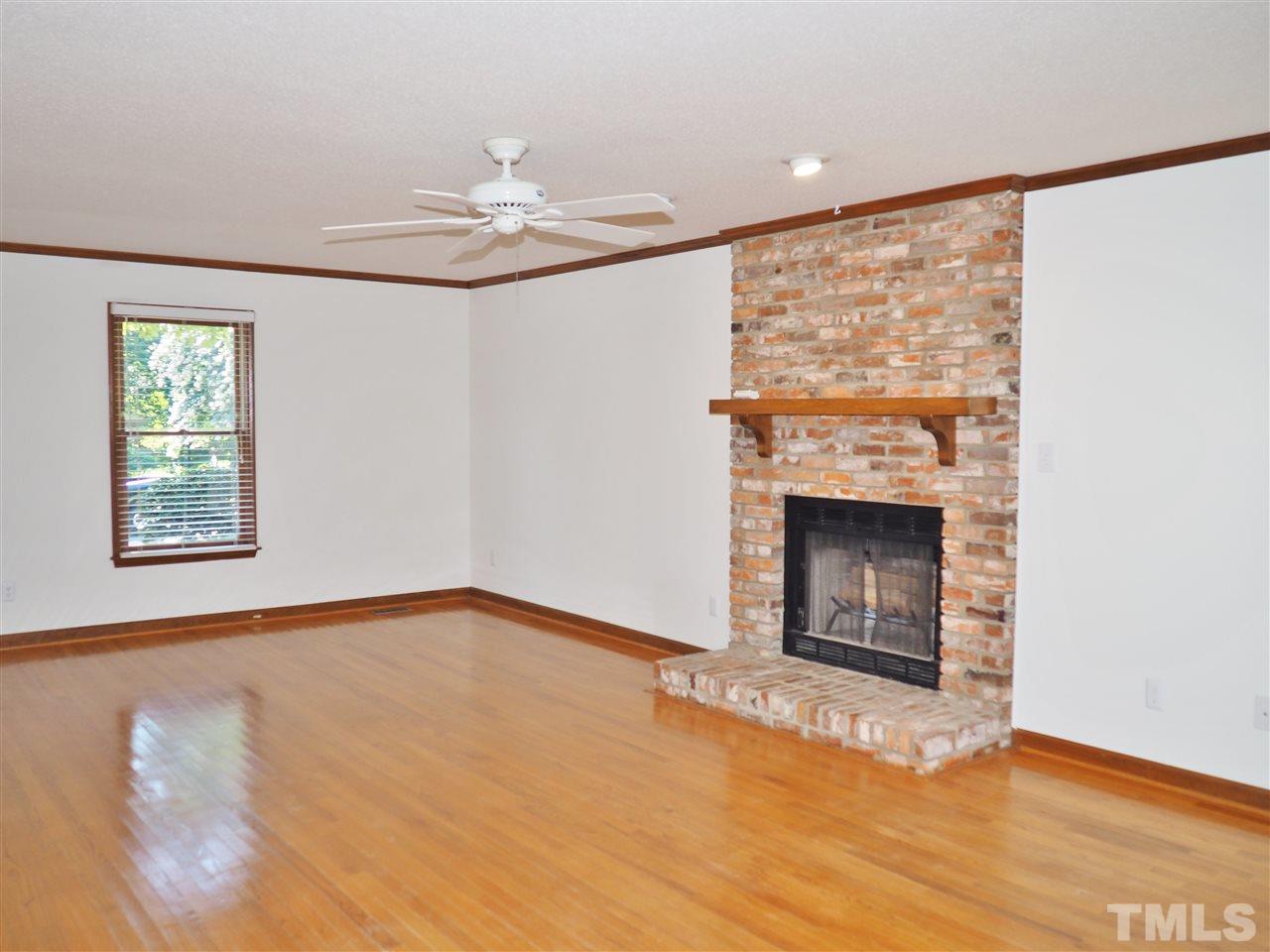 608 Maylands Avenue Raleigh, NC 27615 - Photo 3 of 14 a view of empty room with fireplace and fan