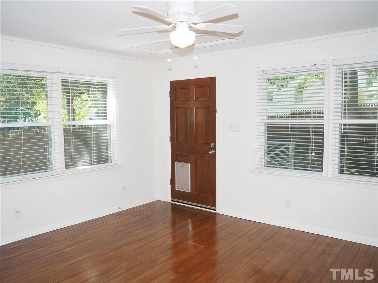 608 Maylands Avenue Raleigh, NC 27615 - Photo 4 of 14 a view of an empty room with wooden floor and a window