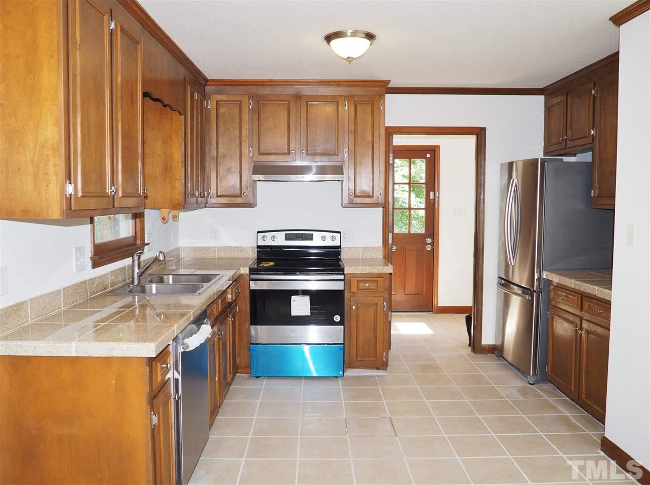 608 Maylands Avenue Raleigh, NC 27615 - Photo 5 of 14 a kitchen with stainless steel appliances granite countertop a refrigerator stove and sink