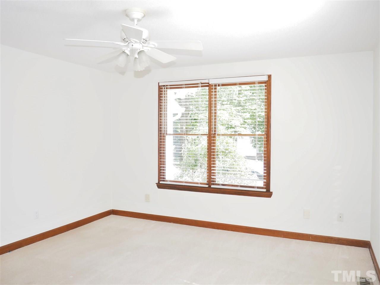 608 Maylands Avenue Raleigh, NC 27615 - Photo 8 of 14 a view of a room with a window and a chandelier fan