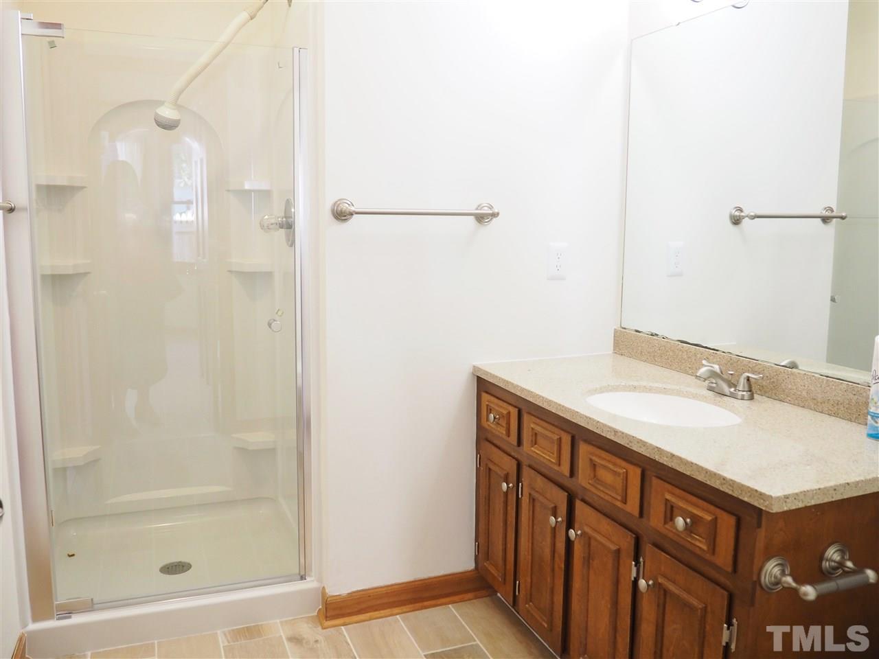 608 Maylands Avenue Raleigh, NC 27615 - Photo 9 of 14 a bathroom with a sink and a mirror