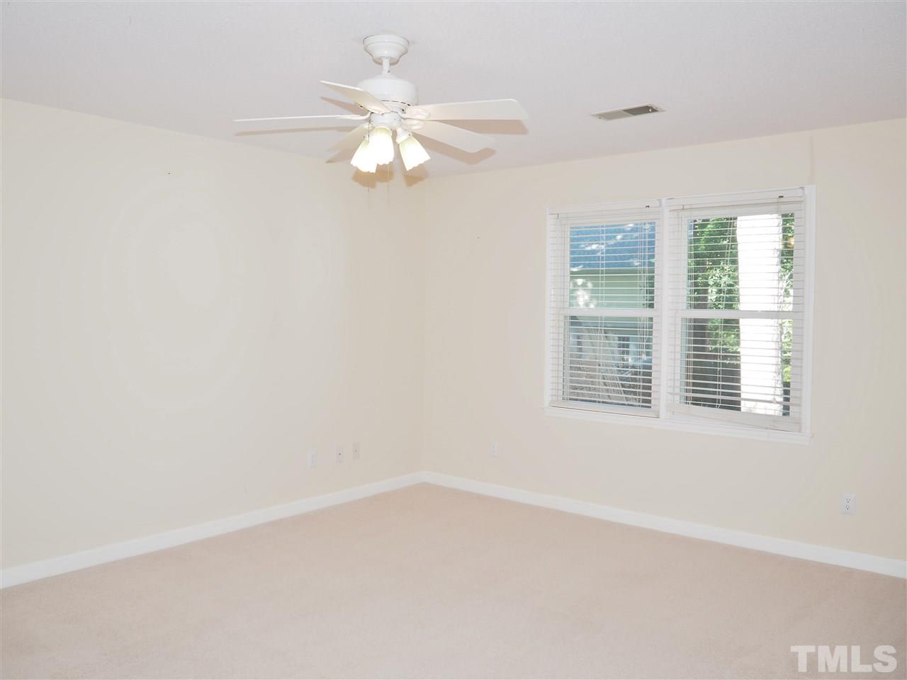 608 Maylands Avenue Raleigh, NC 27615 - Photo 10 of 14 an empty room with windows and fan