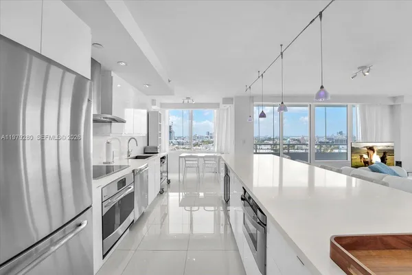 a kitchen with kitchen island a large counter top a sink and cabinets