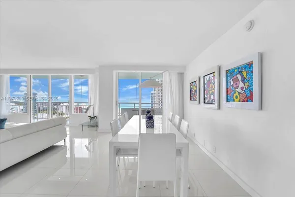 a view of a dining room with furniture and a floor to ceiling window