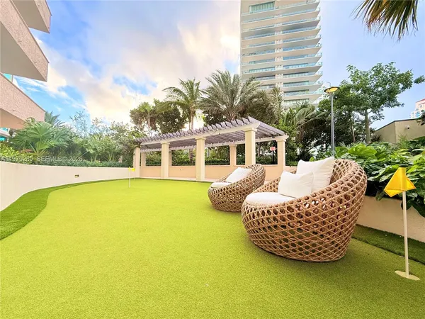 a view of a palm trees front of house