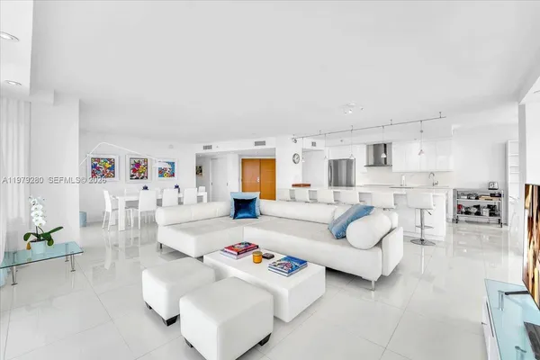 a bedroom with furniture and a large window