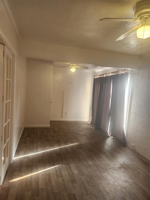 12911 Mitchwin Road Farmers Branch, TX 75234 - Photo 13 of 38 Unfurnished room with a textured ceiling, ceiling fan, and wood finished floors