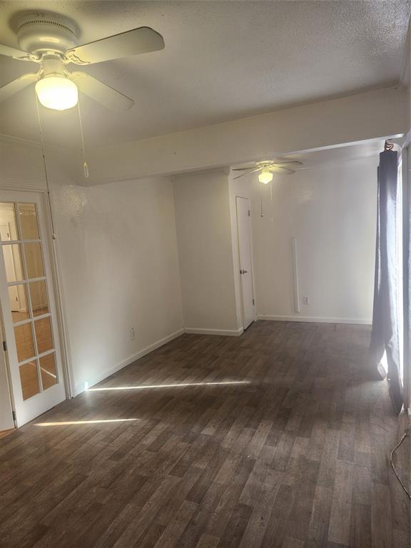 12911 Mitchwin Road Farmers Branch, TX 75234 - Photo 14 of 38 Empty room with a textured ceiling, wood finished floors, baseboards, and ceiling fan