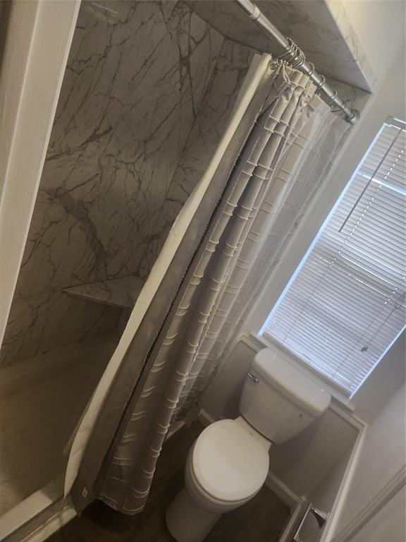 12911 Mitchwin Road Farmers Branch, TX 75234 - Photo 19 of 38 Bathroom featuring curtained shower and toilet