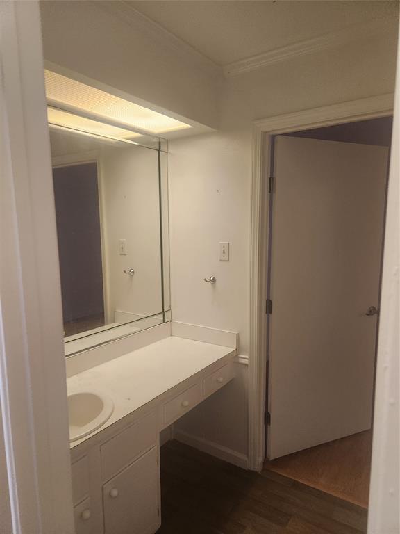 12911 Mitchwin Road Farmers Branch, TX 75234 - Photo 20 of 38 Bathroom with vanity, crown molding, and wood finished floors