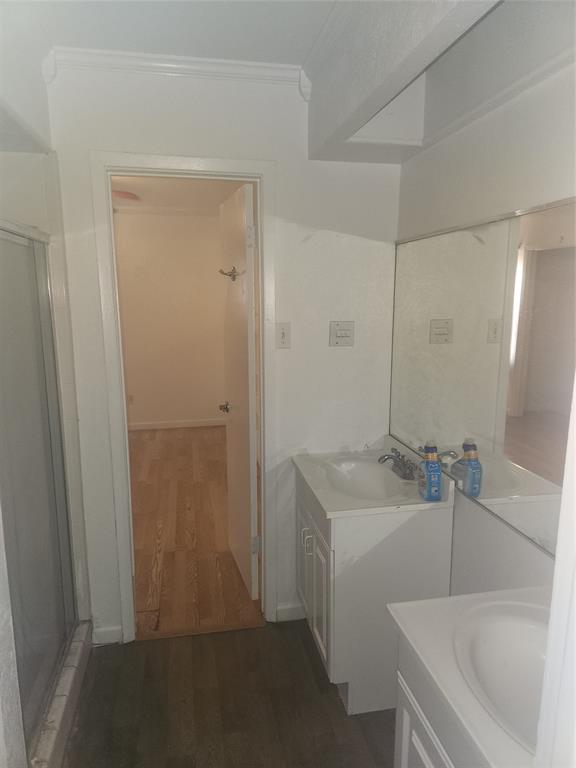 12911 Mitchwin Road Farmers Branch, TX 75234 - Photo 29 of 38 Bathroom featuring a shower with shower door, wood finished floors, vanity, and crown molding