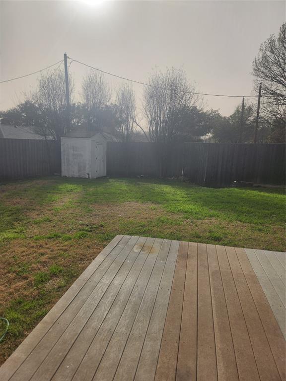 12911 Mitchwin Road Farmers Branch, TX 75234 - Photo 34 of 38 Wooden deck featuring an outbuilding, a shed, and a fenced backyard