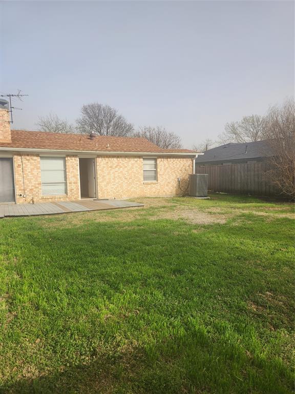 12911 Mitchwin Road Farmers Branch, TX 75234 - Photo 36 of 38 View of yard featuring central AC unit and fence