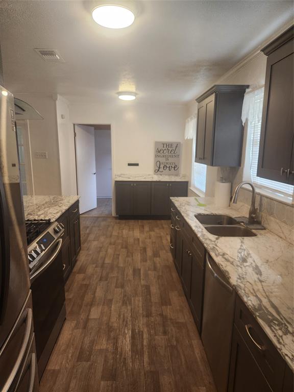 12911 Mitchwin Road Farmers Branch, TX 75234 - Photo 10 of 38 Kitchen featuring visible vents, a sink, dishwashing machine, fridge, and range