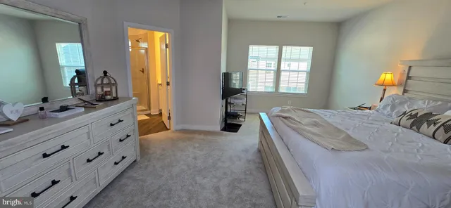 a bedroom with a bed and a lamp