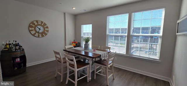 a view of a dining room with furniture and a window