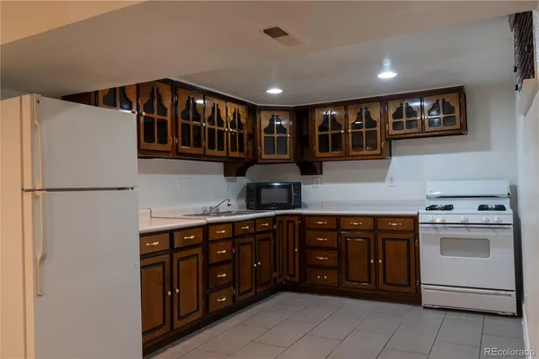 a kitchen with stainless steel appliances granite countertop a sink and a refrigerator