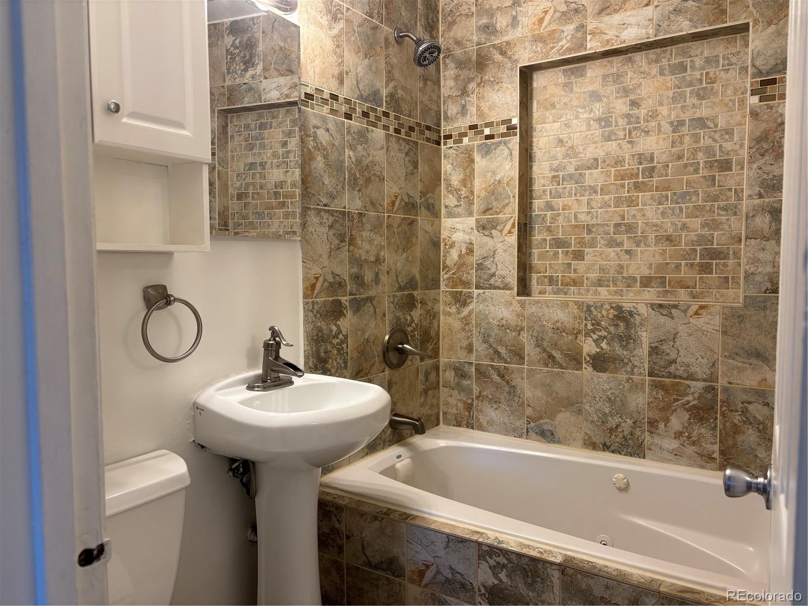 695 South Bryant Street Denver, CO 80219 - Photo 19 of 28 a bathroom with a sink a toilet and shower