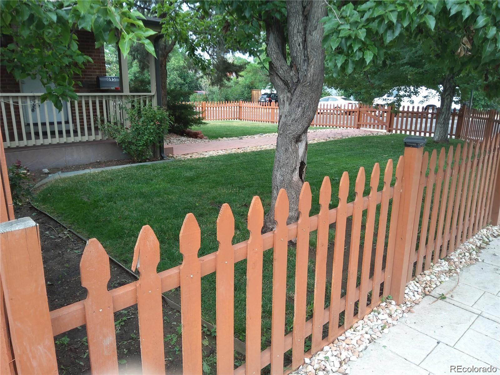 695 South Bryant Street Denver, CO 80219 - Photo 2 of 28 a view of a wooden fence