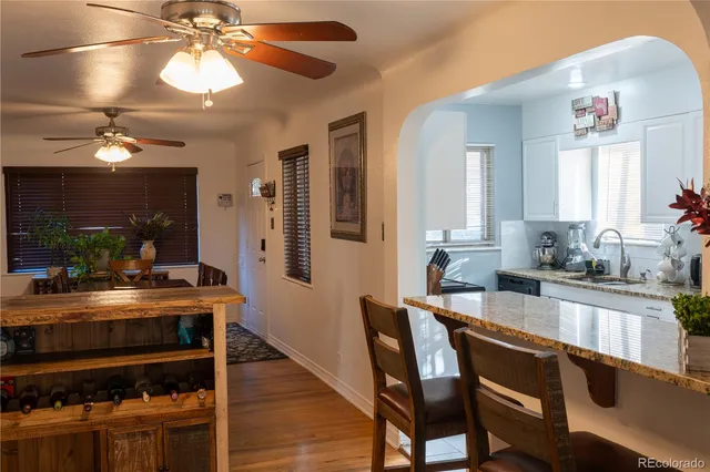 a dining room with wooden floor and chandelier