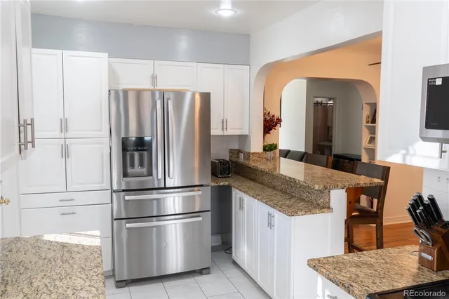 a kitchen with stainless steel appliances granite countertop a refrigerator and a sink