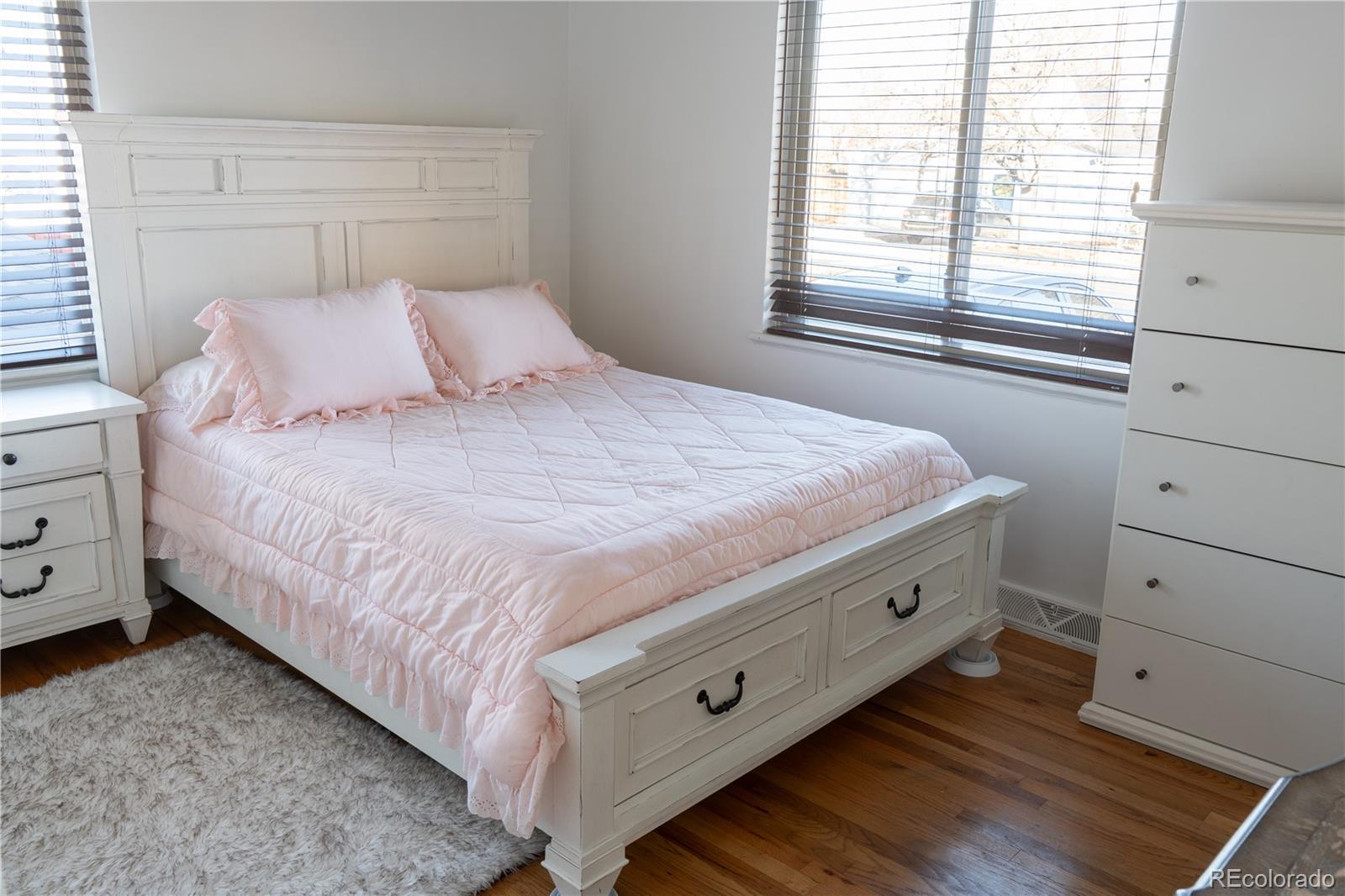 695 South Bryant Street Denver, CO 80219 - Photo 10 of 28 a bedroom with a bed and a window