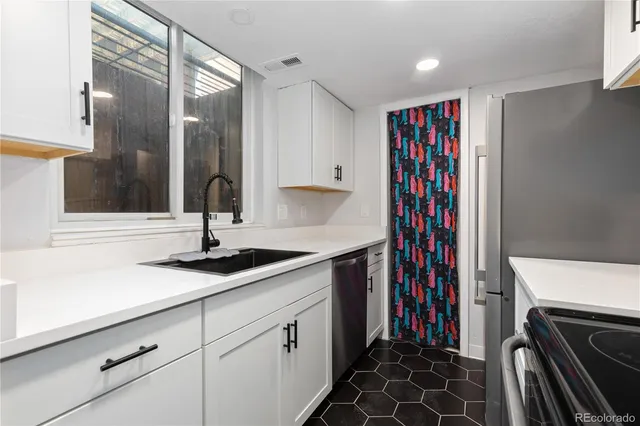 a view of a kitchen with a sink and cabinets