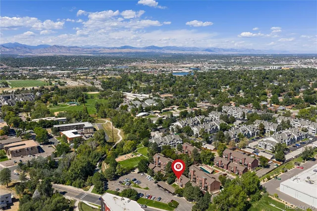 an aerial view of residential houses with city view